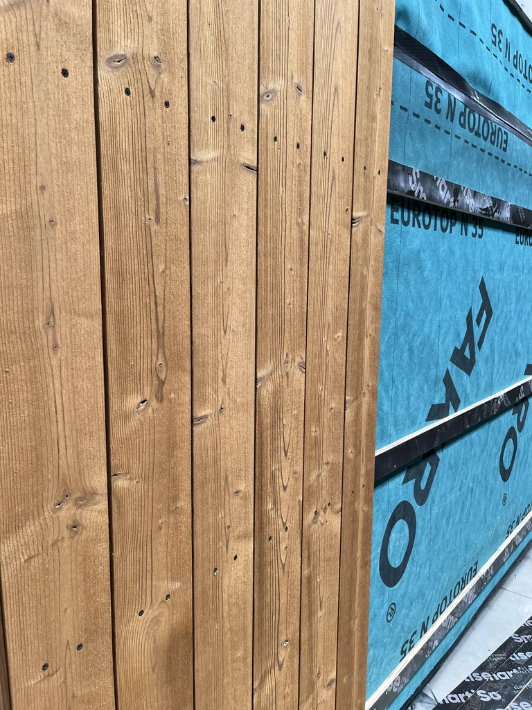 A black steel roof profile over the decking, in production