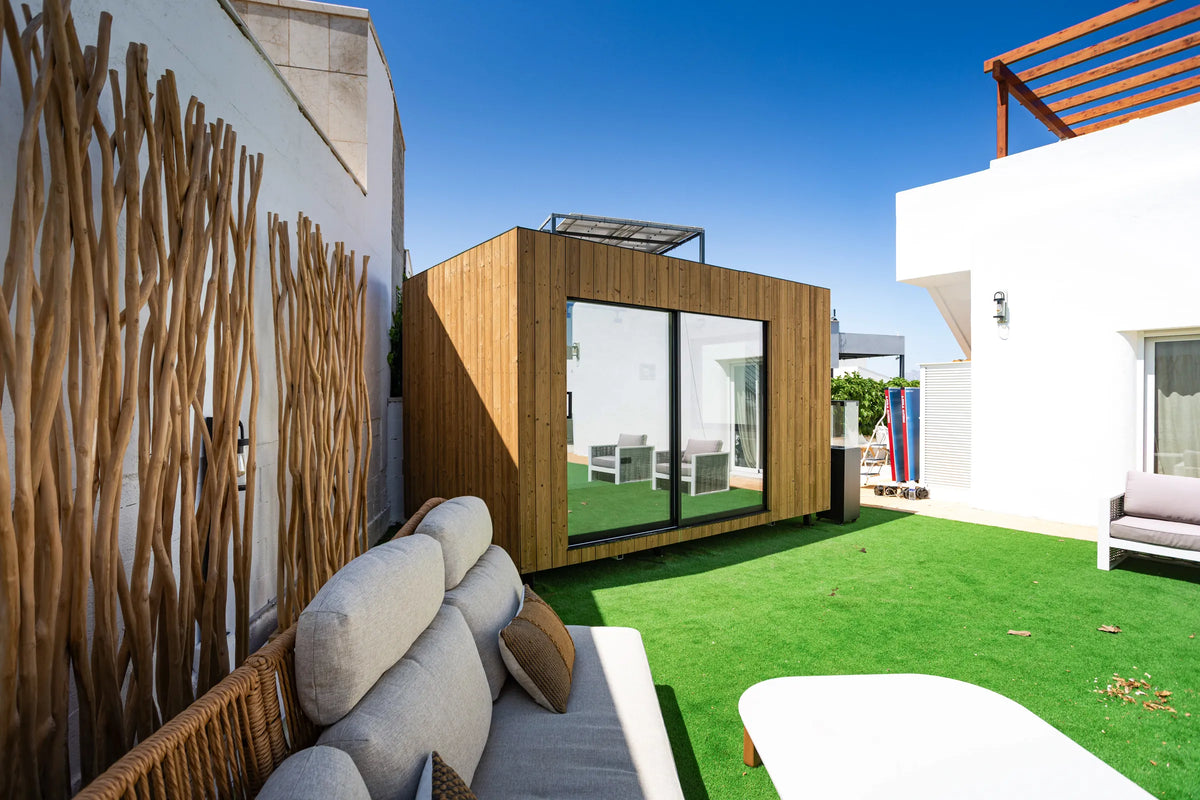 An oak NOOK 10 seen from the garden sofa, its glass doors closed