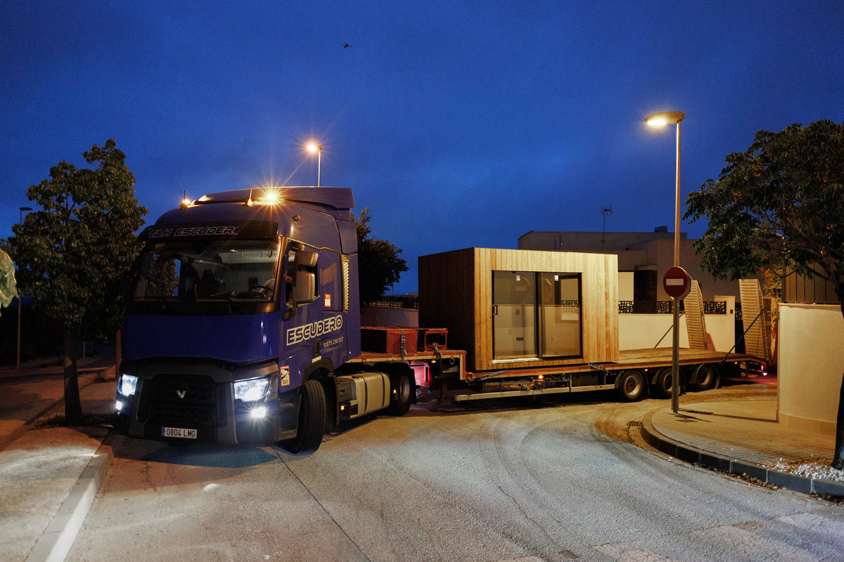 A truck arrives at dusk carrying a finished NOOK 10